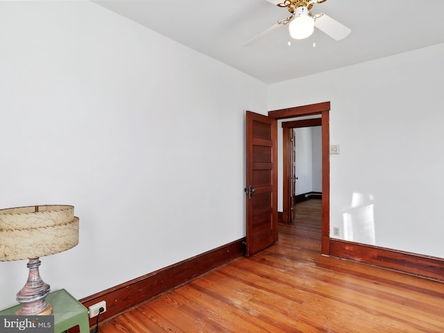 empty room featuring ceiling fan and light wood-type flooring