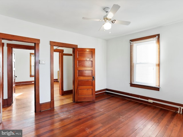 unfurnished bedroom with ceiling fan and dark wood-type flooring