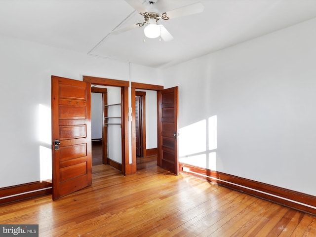 unfurnished bedroom with ceiling fan, light hardwood / wood-style floors, and a closet