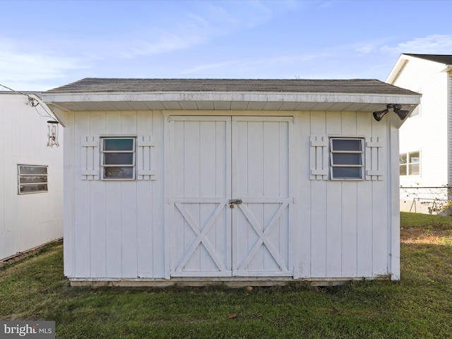 view of outdoor structure with a lawn