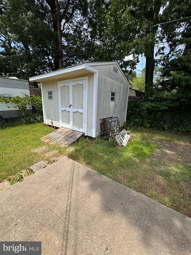 view of outdoor structure featuring a lawn