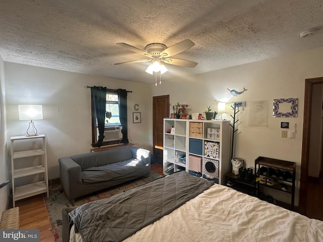 4026 9th St NE, Washington, DC 20017 - bedroom featuring a textured ceiling, wood finished floors, cooling unit, and a ceiling fan