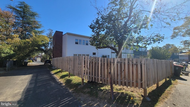 4026 9th St NE, Washington, DC 20017 - view of home's exterior with driveway, a chimney, and fence