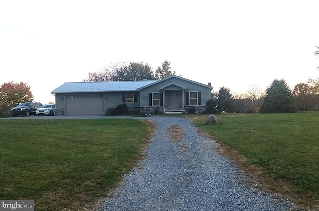 view of front of home featuring a garage and a front lawn