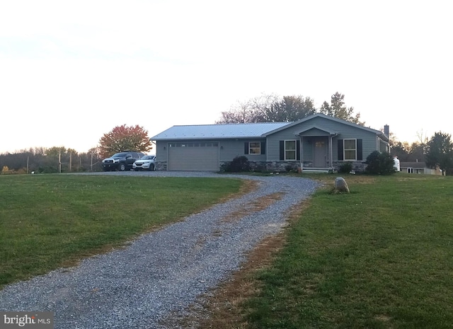 single story home with a garage and a front yard