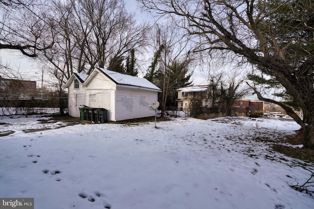 snowy yard with an outbuilding