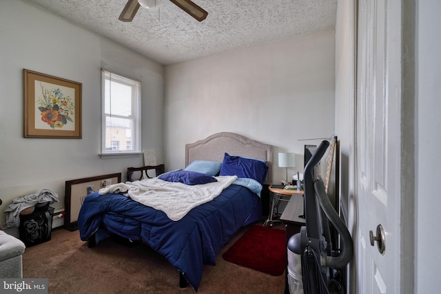 bedroom with a textured ceiling, carpet, and ceiling fan