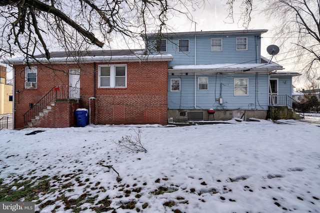 view of snow covered rear of property