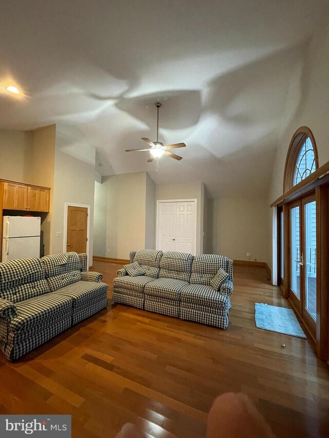 living room with french doors, vaulted ceiling, dark hardwood / wood-style flooring, and ceiling fan