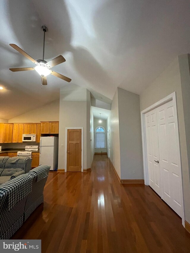 living room featuring ceiling fan, lofted ceiling, and dark hardwood / wood-style floors