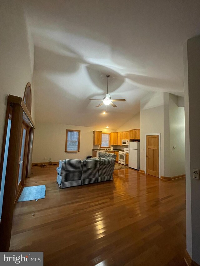 living room with hardwood / wood-style floors, vaulted ceiling, and ceiling fan