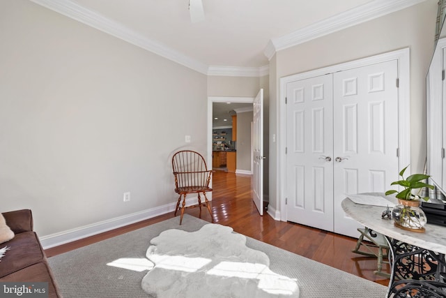 sitting room with crown molding and dark hardwood / wood-style flooring