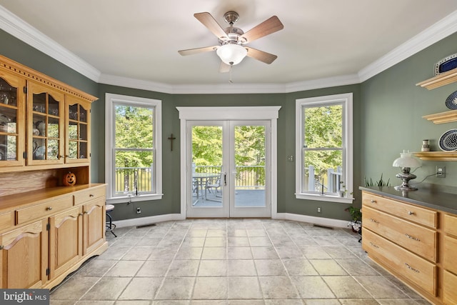 doorway to outside featuring ornamental molding, ceiling fan, and plenty of natural light