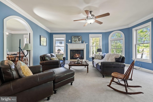 living room with ornamental molding, light carpet, and a healthy amount of sunlight