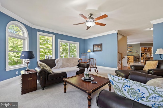 carpeted living room with ornamental molding and ceiling fan