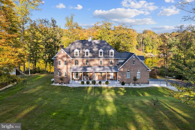 back of property featuring a lawn