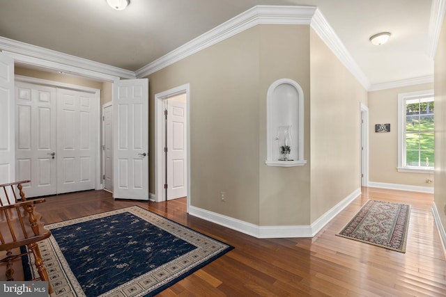 foyer entrance featuring crown molding and hardwood / wood-style floors