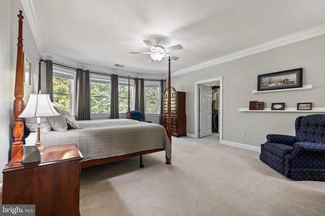 carpeted bedroom featuring ornamental molding and ceiling fan