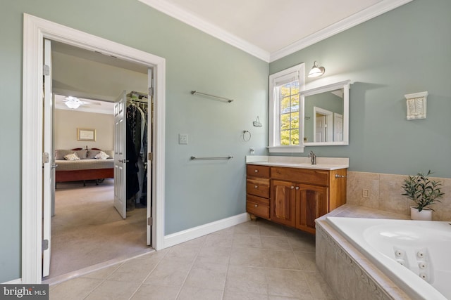 bathroom featuring tile patterned floors, tiled bath, crown molding, vanity, and ceiling fan