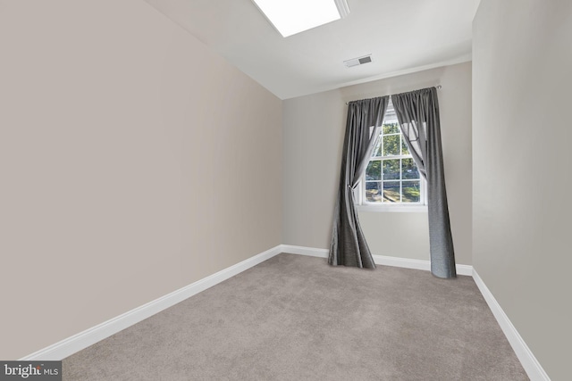 unfurnished room with vaulted ceiling and light colored carpet