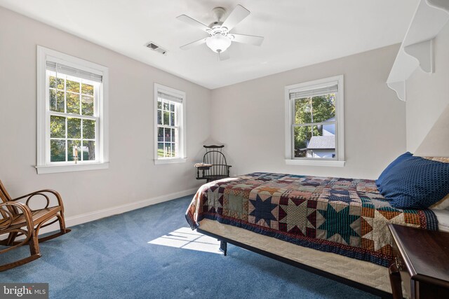 bedroom featuring multiple windows, carpet flooring, and ceiling fan