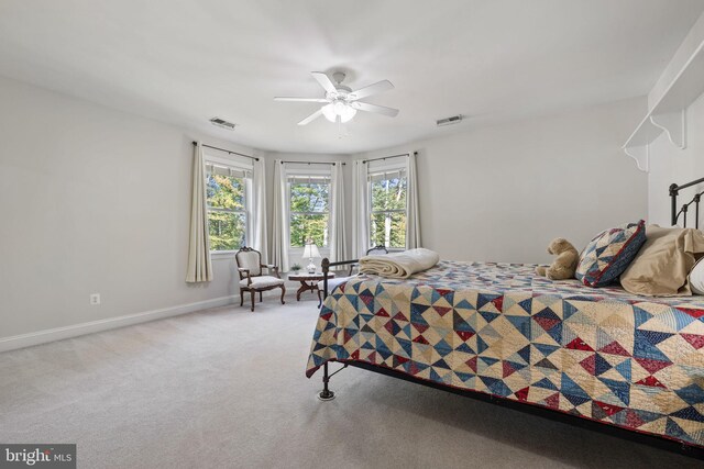 bedroom featuring light carpet and ceiling fan