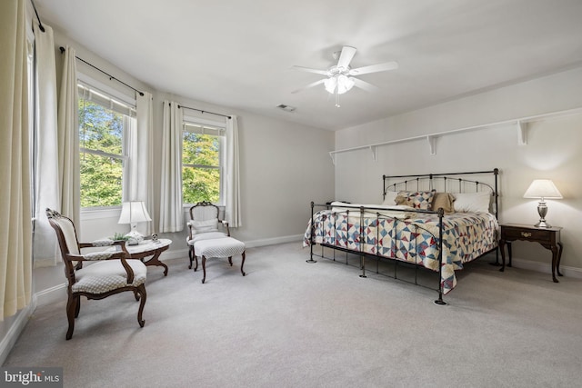 bedroom featuring light colored carpet and ceiling fan