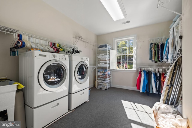 washroom featuring washing machine and dryer and dark colored carpet