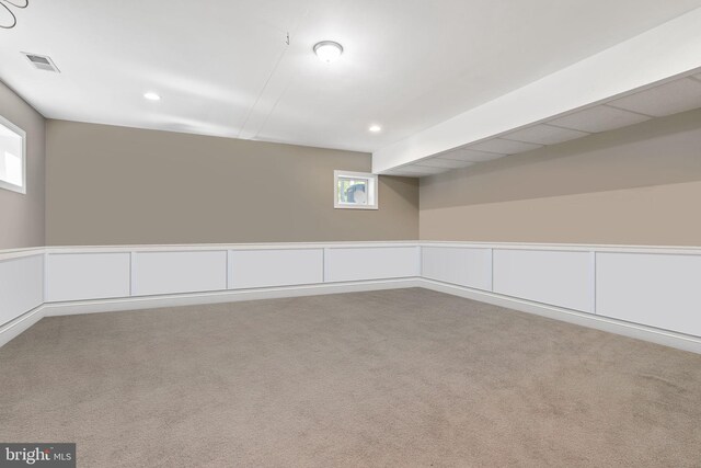 basement featuring a healthy amount of sunlight and carpet