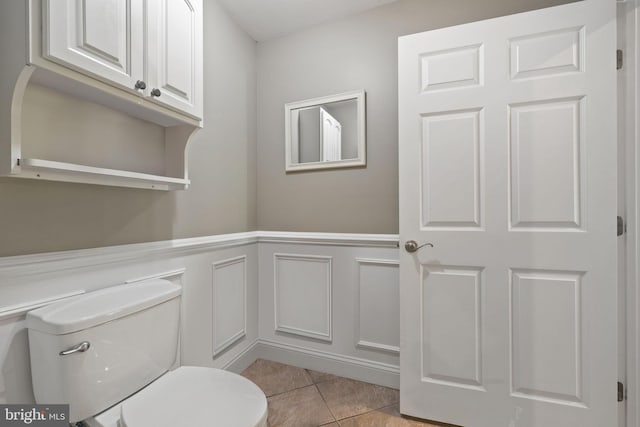 bathroom with toilet and tile patterned flooring