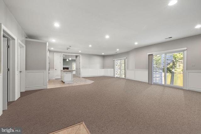 unfurnished living room featuring light colored carpet