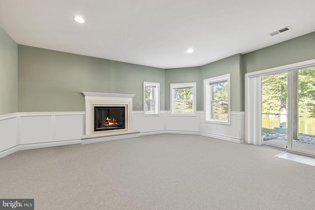 unfurnished living room featuring light carpet