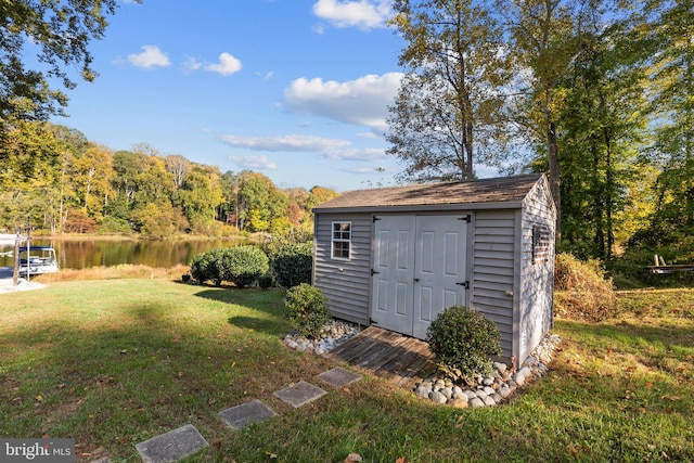 view of outdoor structure with a yard and a water view