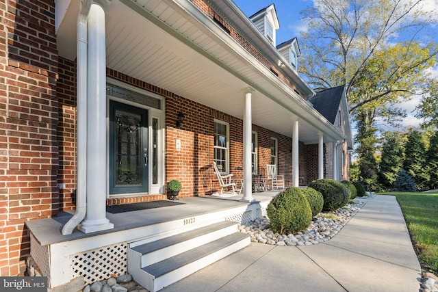 view of exterior entry with a porch