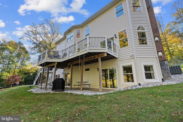 back of property featuring a yard and a deck