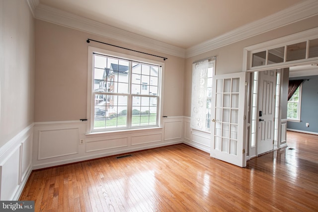 empty room featuring light wood-type flooring and plenty of natural light