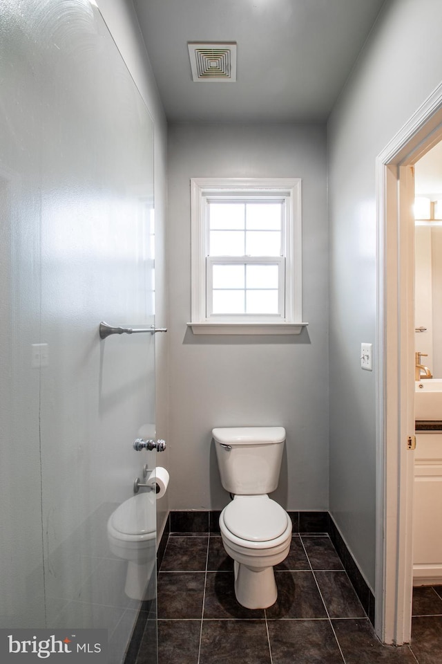 bathroom with tile patterned floors and toilet