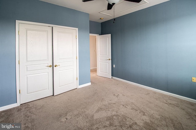 unfurnished bedroom featuring light carpet, a closet, and ceiling fan