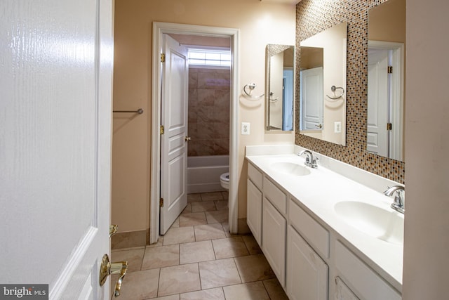 bathroom featuring tile patterned floors, vanity, and toilet