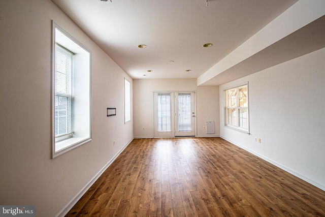 spare room with french doors and dark hardwood / wood-style floors