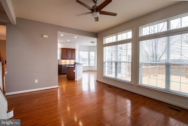 unfurnished living room featuring ceiling fan and light hardwood / wood-style flooring