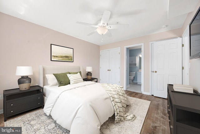 bedroom featuring ceiling fan, dark hardwood / wood-style floors, and ensuite bath