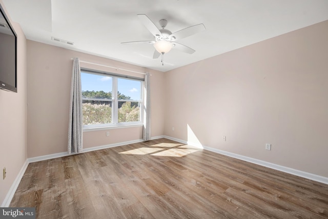 spare room with light hardwood / wood-style floors and ceiling fan