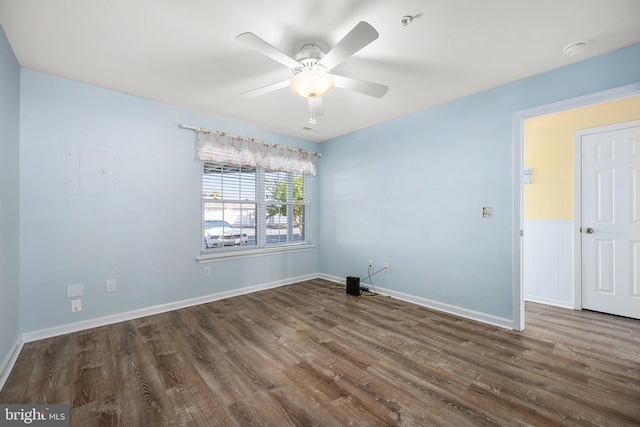 empty room with hardwood / wood-style floors and ceiling fan