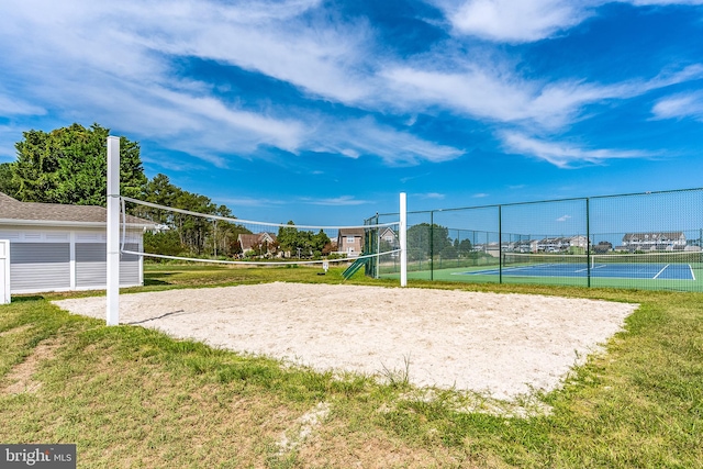 surrounding community with volleyball court, a lawn, and tennis court