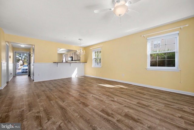 unfurnished living room featuring dark hardwood / wood-style floors and a wealth of natural light