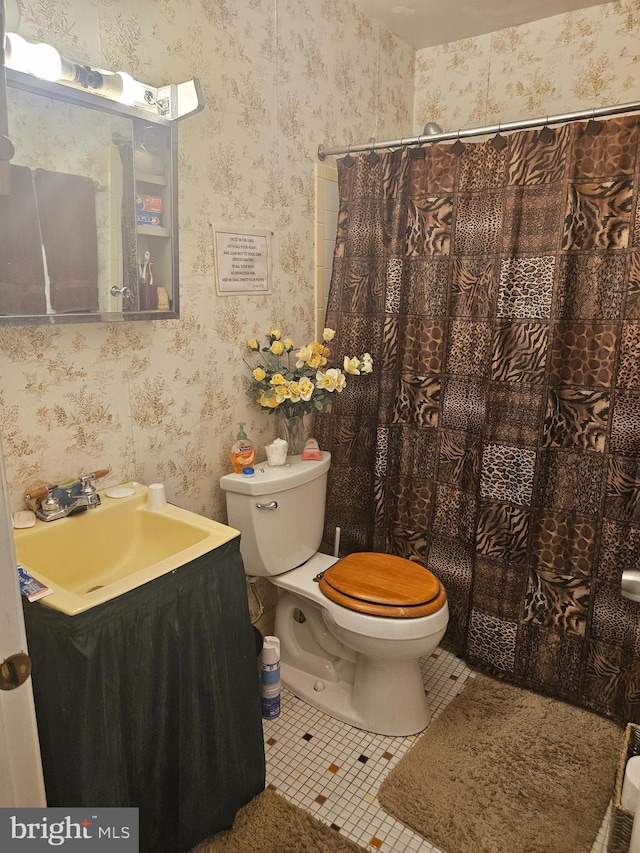 bathroom featuring tile patterned floors, vanity, and toilet