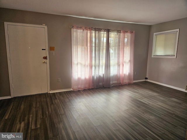 unfurnished room featuring dark wood-type flooring