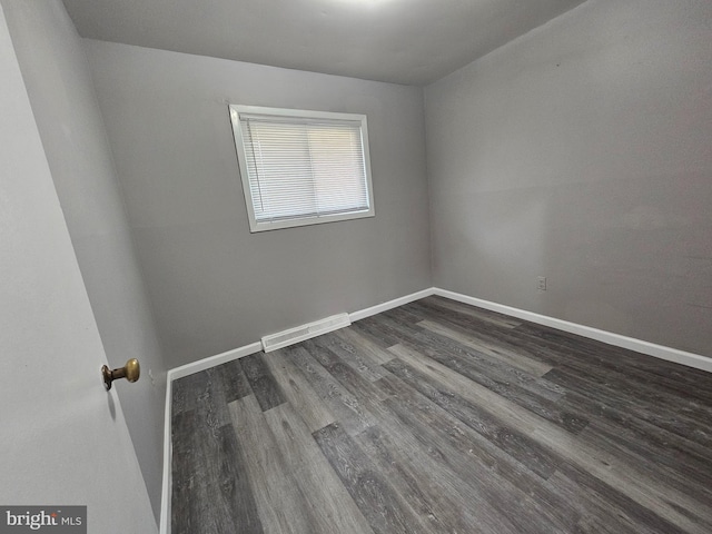 spare room with dark hardwood / wood-style flooring