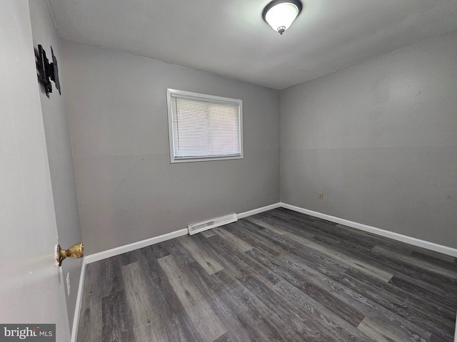 unfurnished room with dark hardwood / wood-style floors